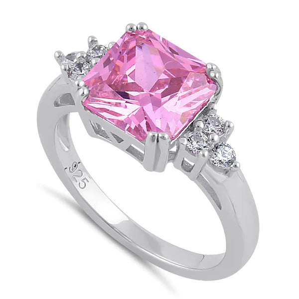 3 carat pink princess cut center stone
Unique triangular cluster design 3 small round clear Cubic Zirconia stones on each side
Available in sizes 6 through 10