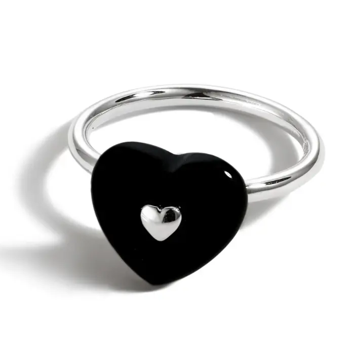 This ring has a silver band, black enamel heart, with a smaller silver inset.
Made of 925 sterling silver plated in rhodium
Features black enamel
This ring is lead and nickel-free.
