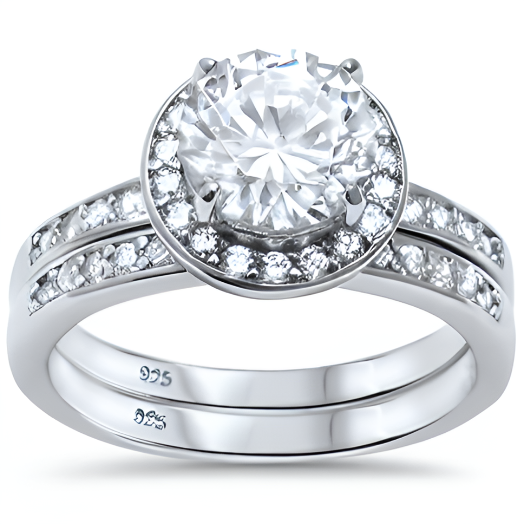 Features a 2-carat round cut center stone
Surrounded by a beautiful halo set in a prong setting
Includes the matching band to complete the set
Available in sizes 4 through 11