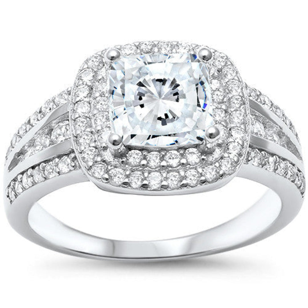 Features a dazzling 2 Carat princess cut ring
Intricate double halo of pavé stones down the band
Sterling silver with Rhodium plating
Available in sizes 4 through 11
Also available in gold