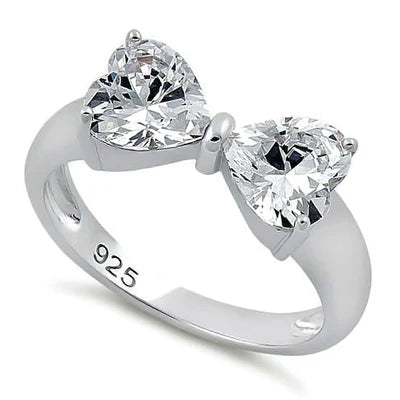 Features two one carat heart-shaped clear cz stones converge at the top
The hearts form a bow-like shape.
Made of 925 sterling silver and Rhodium plated with a high polish finish