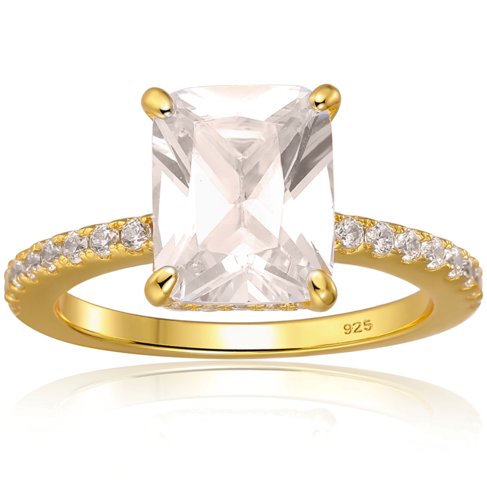 Features a 3-carat center emerald-cut stone with a hidden halo underneath the main stone
Triple A CZ stones in a sterling silver setting
14K gold plating
Set in a gorgeous 4 prong setting
Available in silver and in sizes 4 through 11