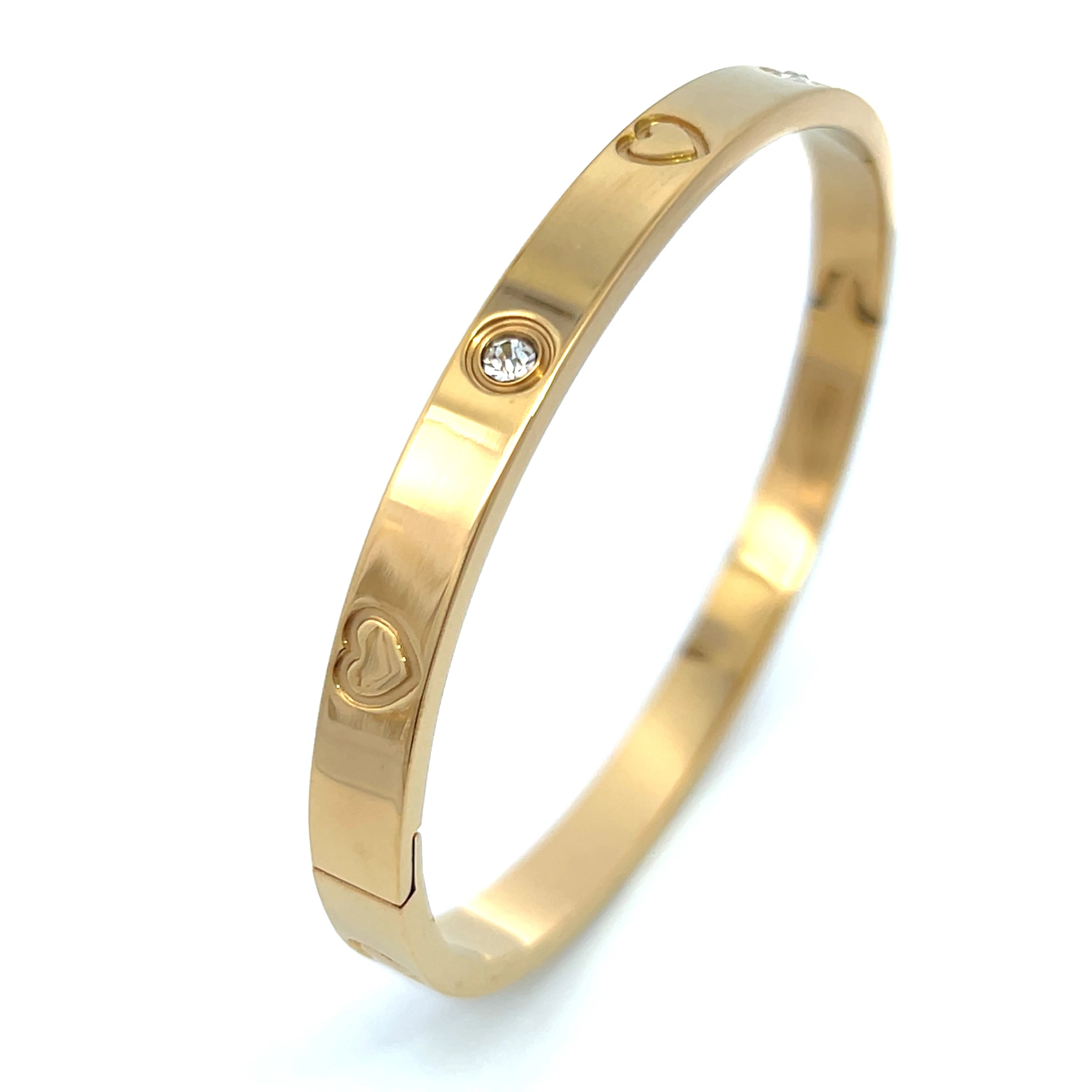 Choose from gold, silver, or rose gold. This versatile bracelet can be dressed up or down.
Made with high-quality stainless steel and plated with 18K-gold, rhodium or rose gold
Features 6 engraved hearts and 4 round bezel CZ stones.
Measures 2 inches in width and 2 1/2 inches in length. The bracelet's face is 1cm wide and 2mm thick.