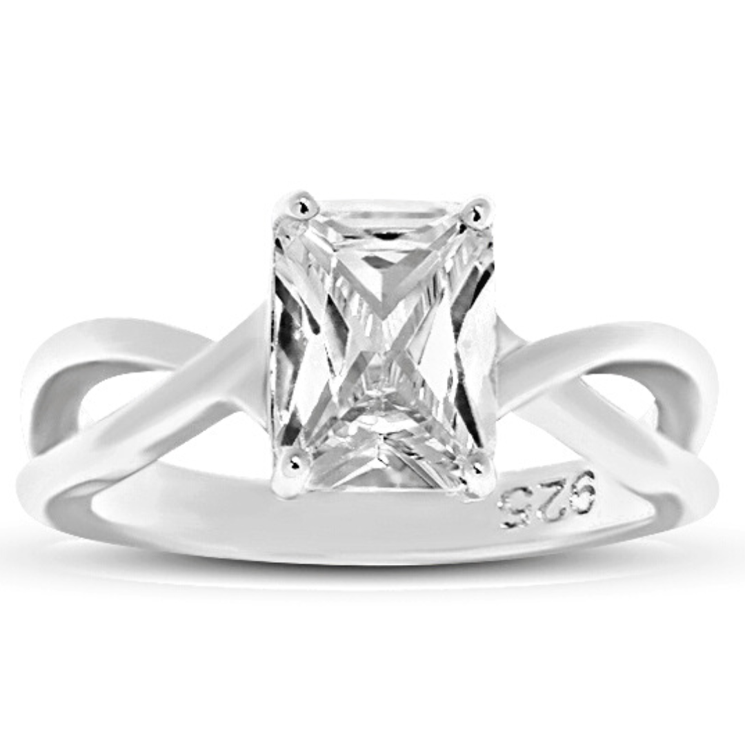 Features a 2-carat classically cut emerald shape center stone
Surrounded by an infinity shape set in a prong setting
Sterling silver plated in Rhodium
Size 10 only