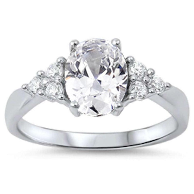 Features 1 carat center stone with ornate round-cut Triple A CZ stones
Set in a prong setting with three round cut stones framing each side and a tapered sterling silver
Available in sizes 5 through 10