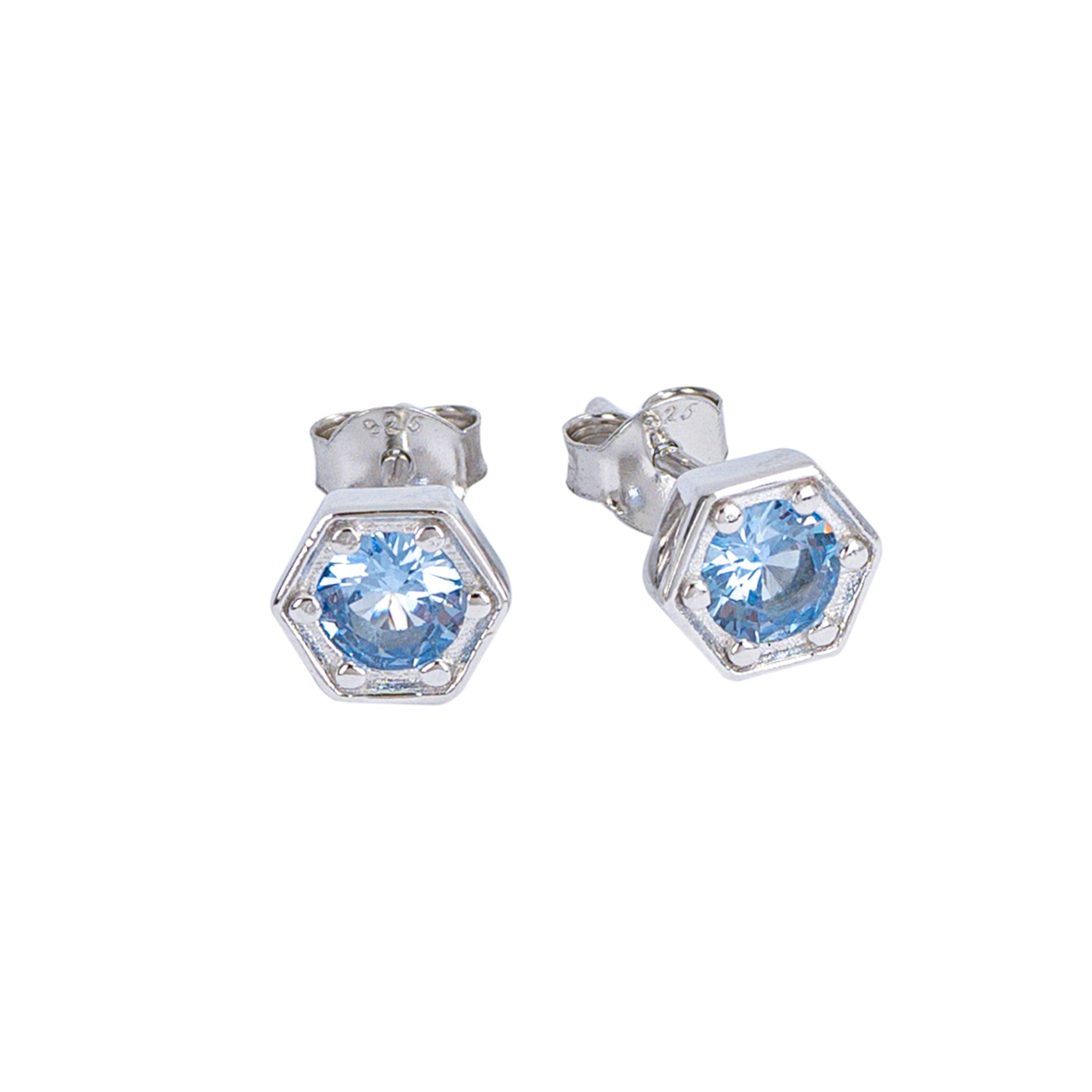 Silver hexagonal earrings with light blue gemstones on a white background
