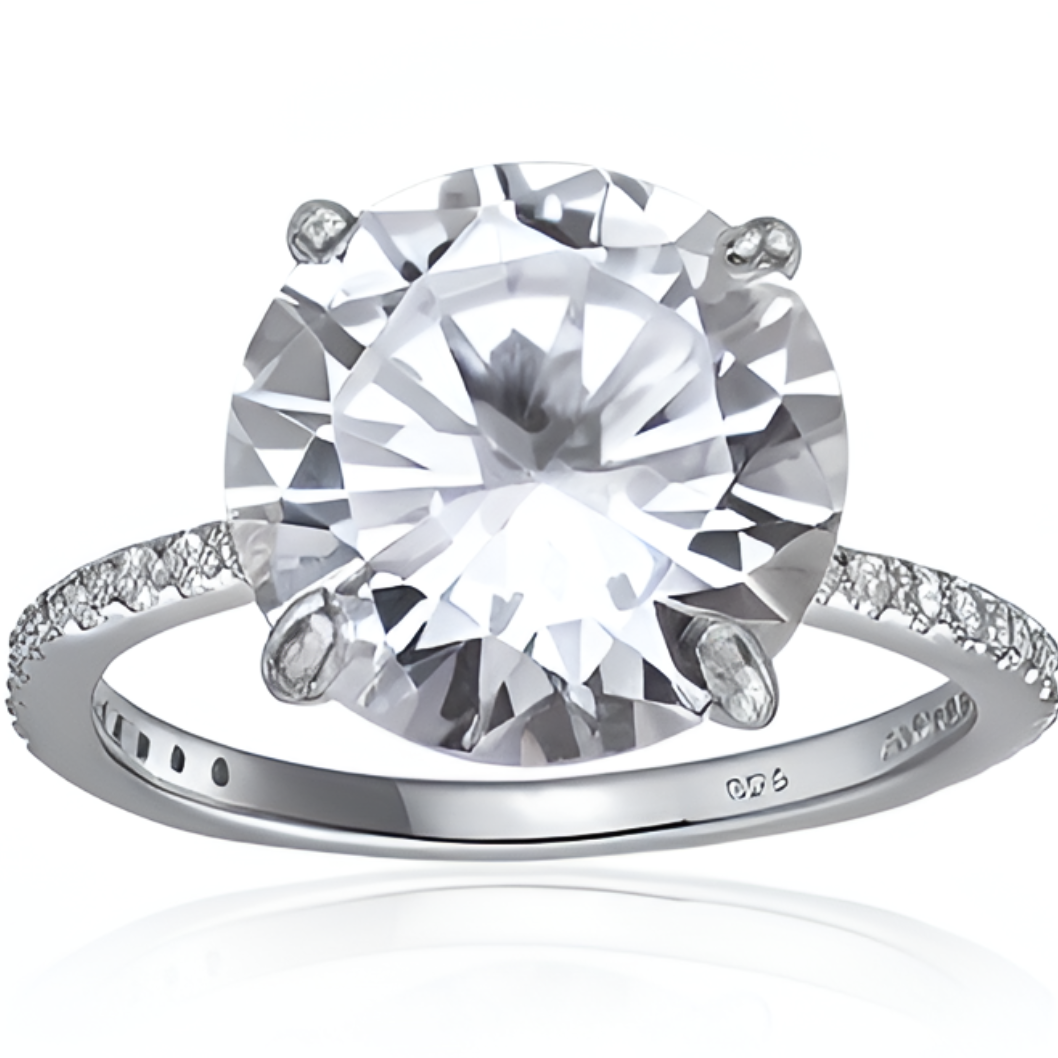 Features 4.5 carat round cut center stone, surrounded by stones embedded in the band
Covering approximately 3/4 of the 1.2 mm thick band, with the prong profile is 1 cm tall
Plated in Rhodium for extra durability and shine
Available in silver and in sizes 4 through 11