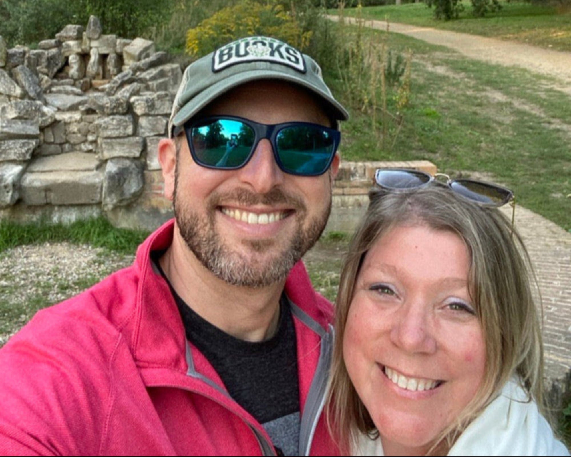 Two people taking a selfie in front of ancient ruins