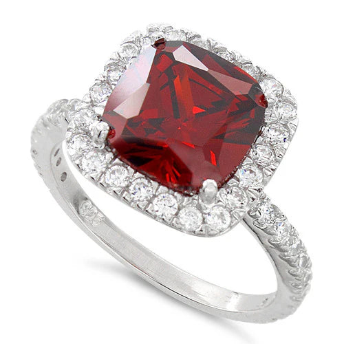The Noelle ring is both romantic and passionate; Wear this beautiful ring as a statement piece or for Girls Night Out!

Features a stunning 2.75-carat cushion garnet center stone
Surrounded by a glorious halo of clear CZ stones in a raised setting
With a pavé band set in a prong setting.
The band is crafted from 925 sterling silver plated in rhodium.