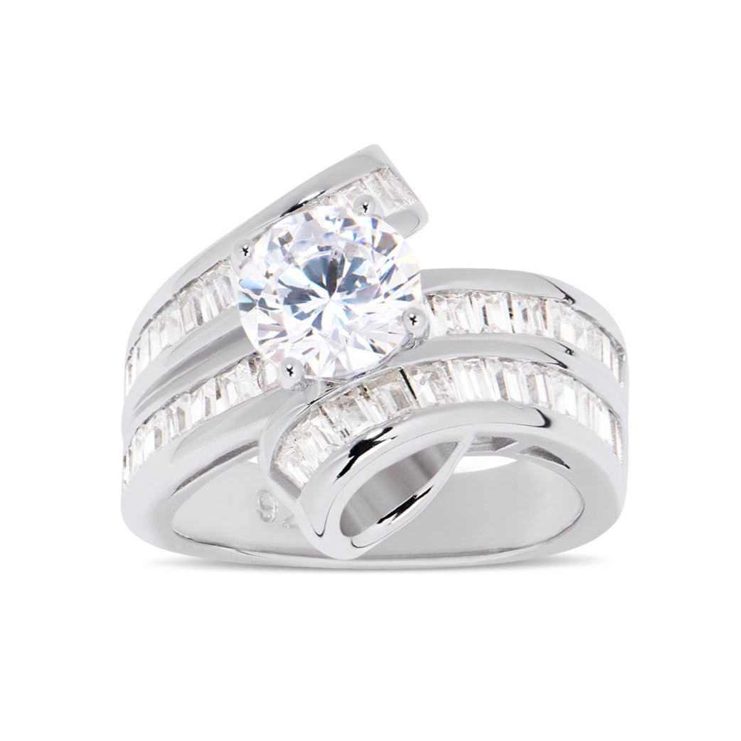 Features a 1.50-carat round center stone
Surrounded by a unique twisted channel emerald band set in a prong setting
Sterling silver and plated in Rhodium
Available in sizes 4 through 10