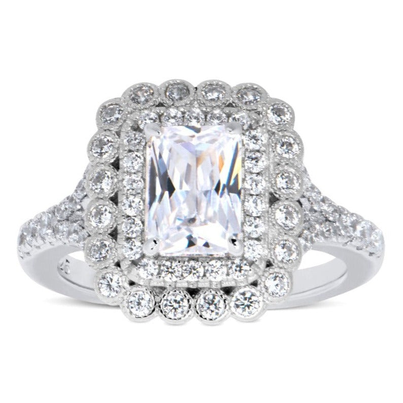 Features a 1.5-carat center Triple A CZ stone
Surrounded by a double halo with multiple round cut stones in 2 sizes
Sterling silver and plated in Rhodium for high shine
Available in 5 through 11
